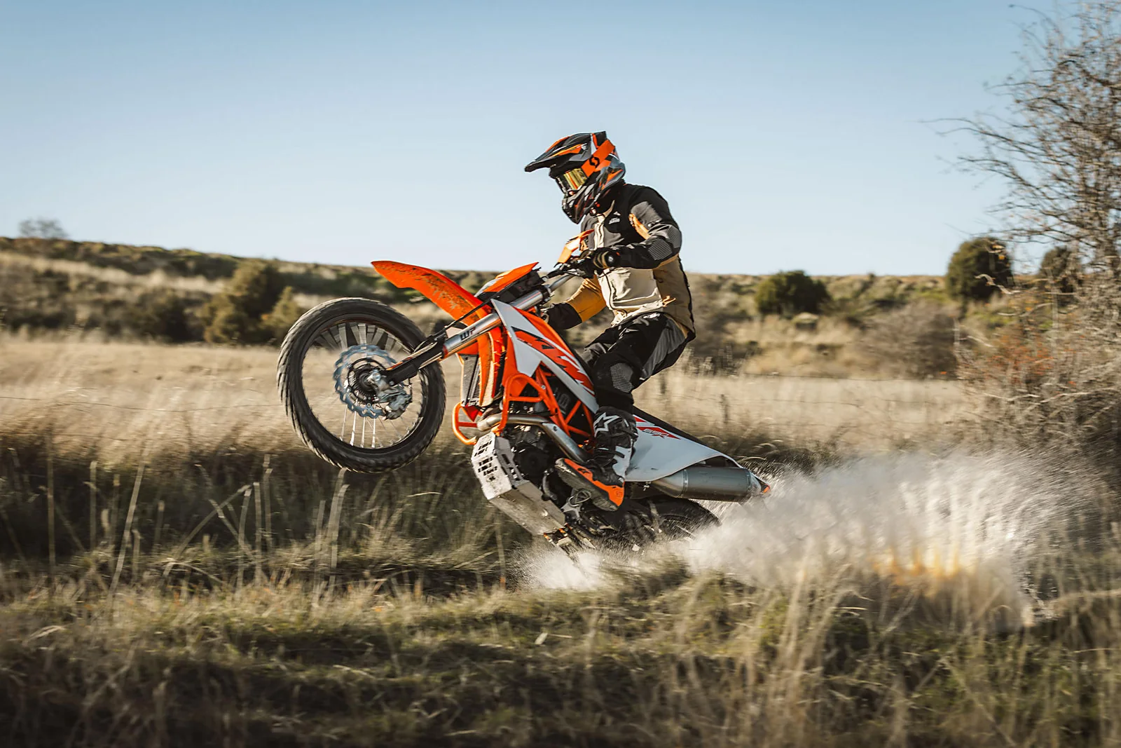 KTM rider on a grassy off-road trail